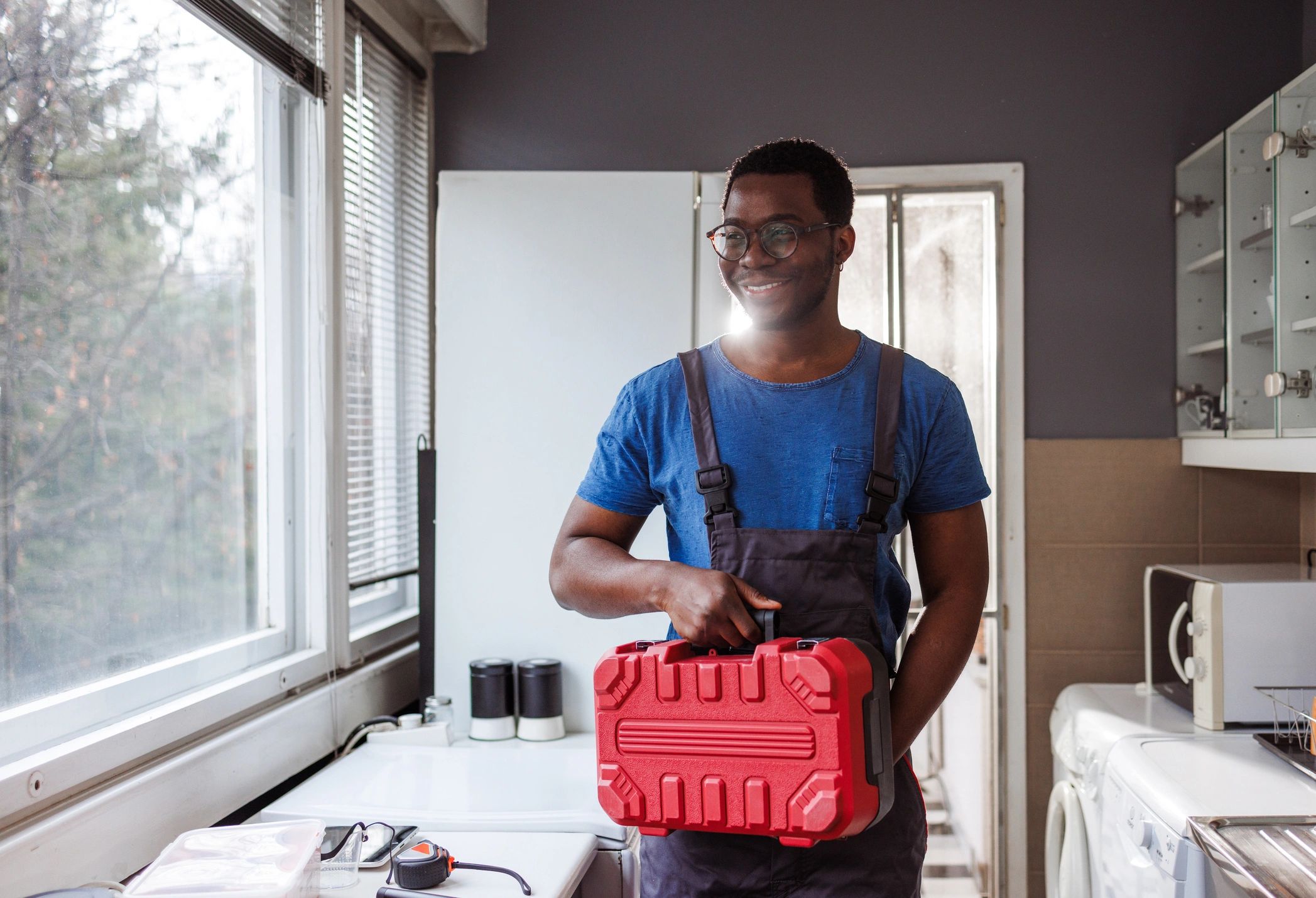 HVAC service technician holding a toolbox