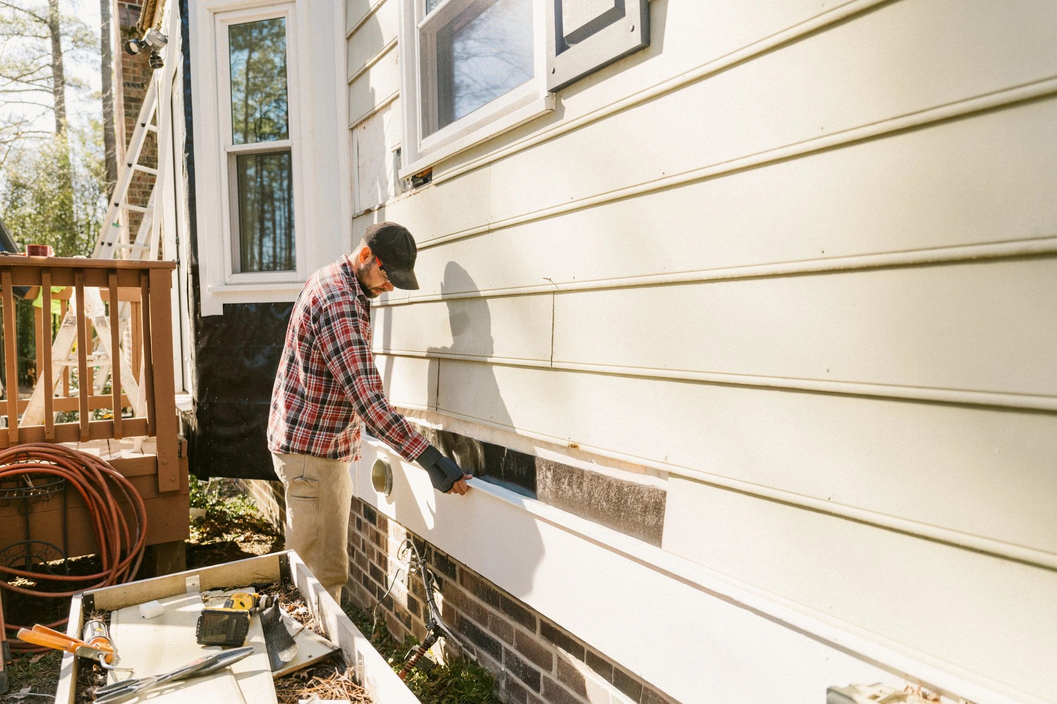 Technician performing air conditioning service at a home